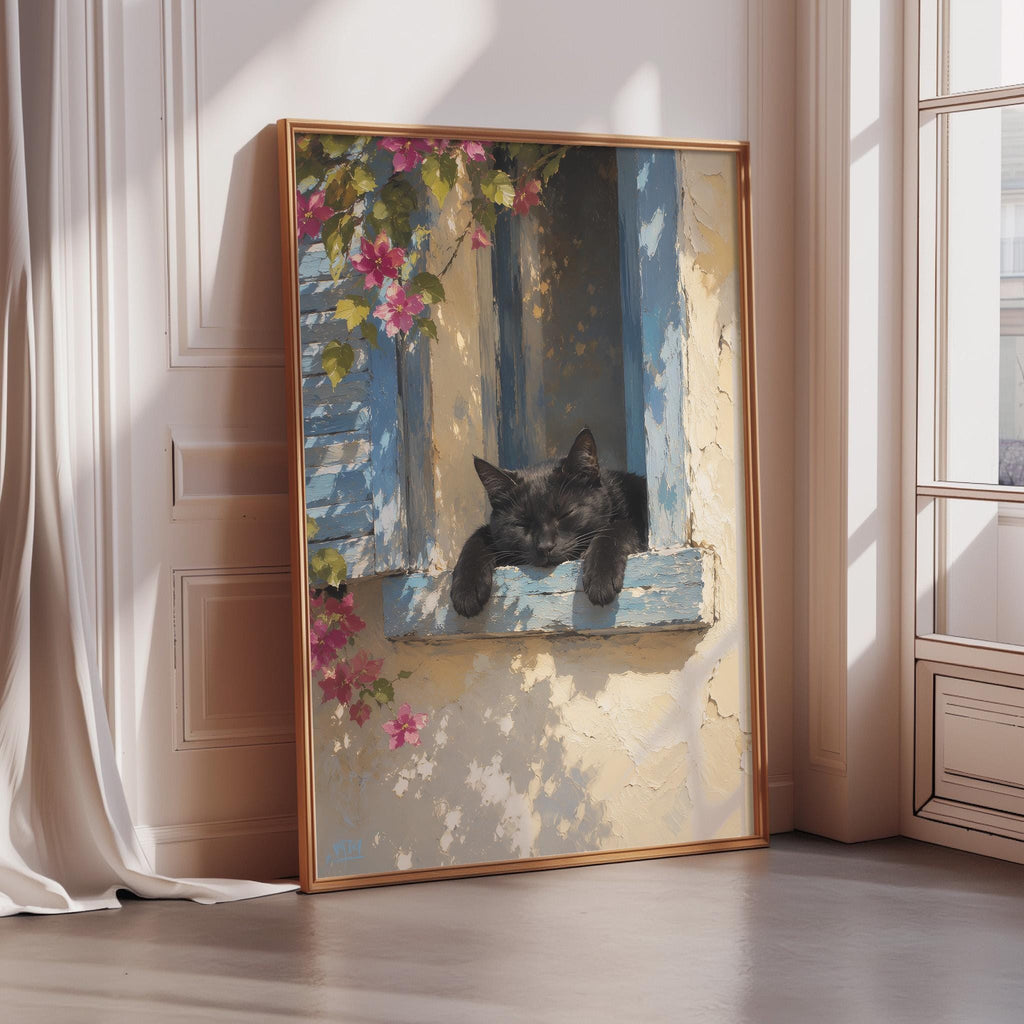 A framed painting depicting a black cat resting on a window sill, with pink flowers and a blue frame.
