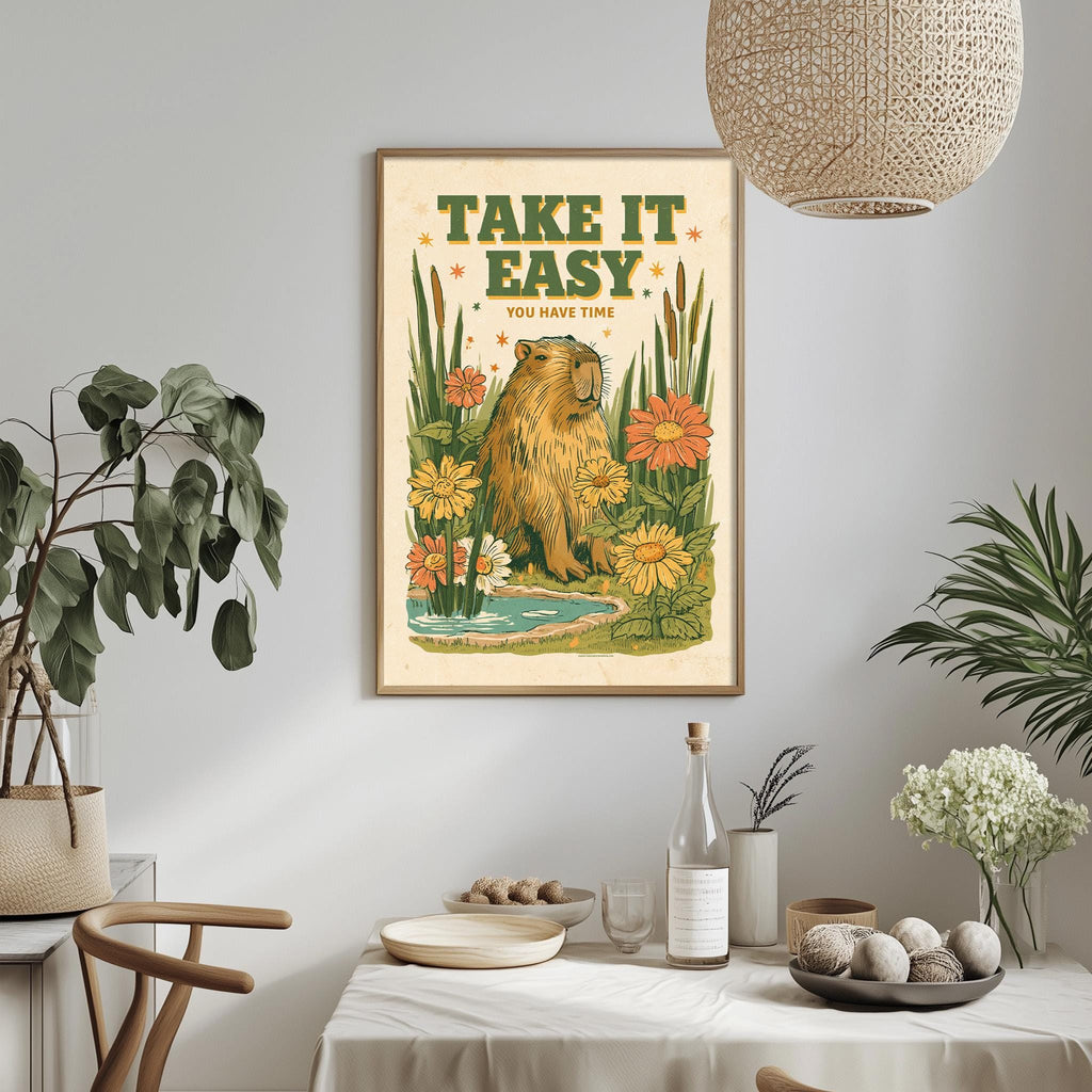 a framed poster with a beaver and flowers hanging on a wall above a table with various items on it.