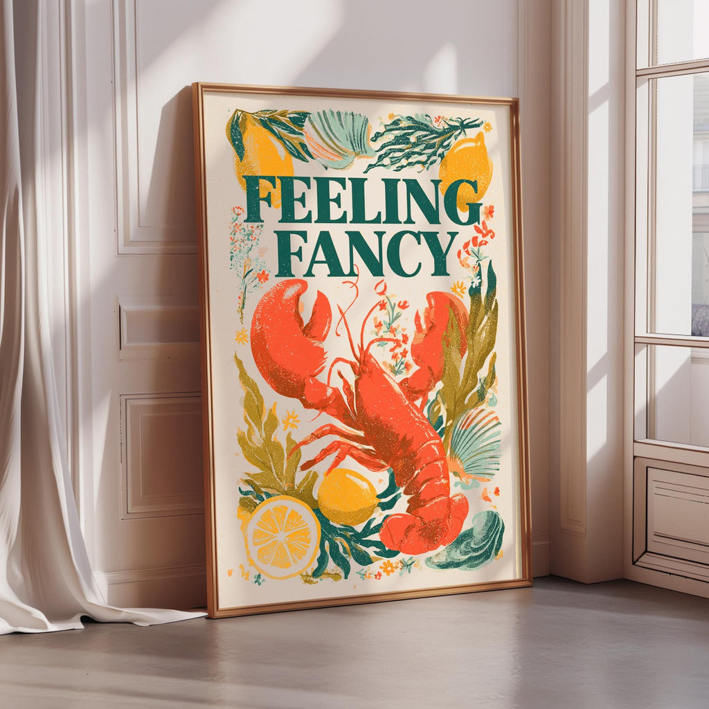 a framed poster with a vibrant illustration of a lobster surrounded by various fruits and vegetables, including a lemon and a watermelon slice. The text on the poster reads "FEELING FANCY".
