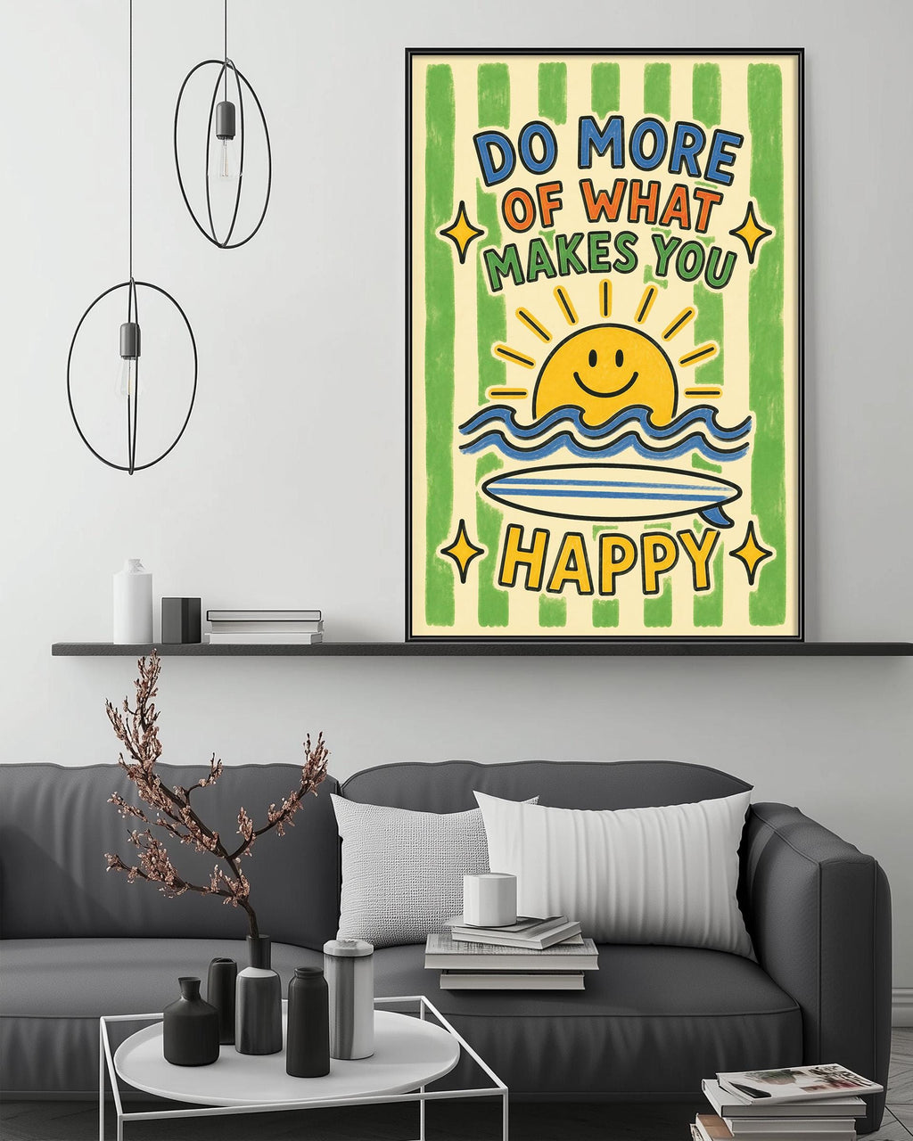a poster with a cheerful message, a sun, and a surfboard, hanging on a wall above a gray couch with a coffee table in front of it.