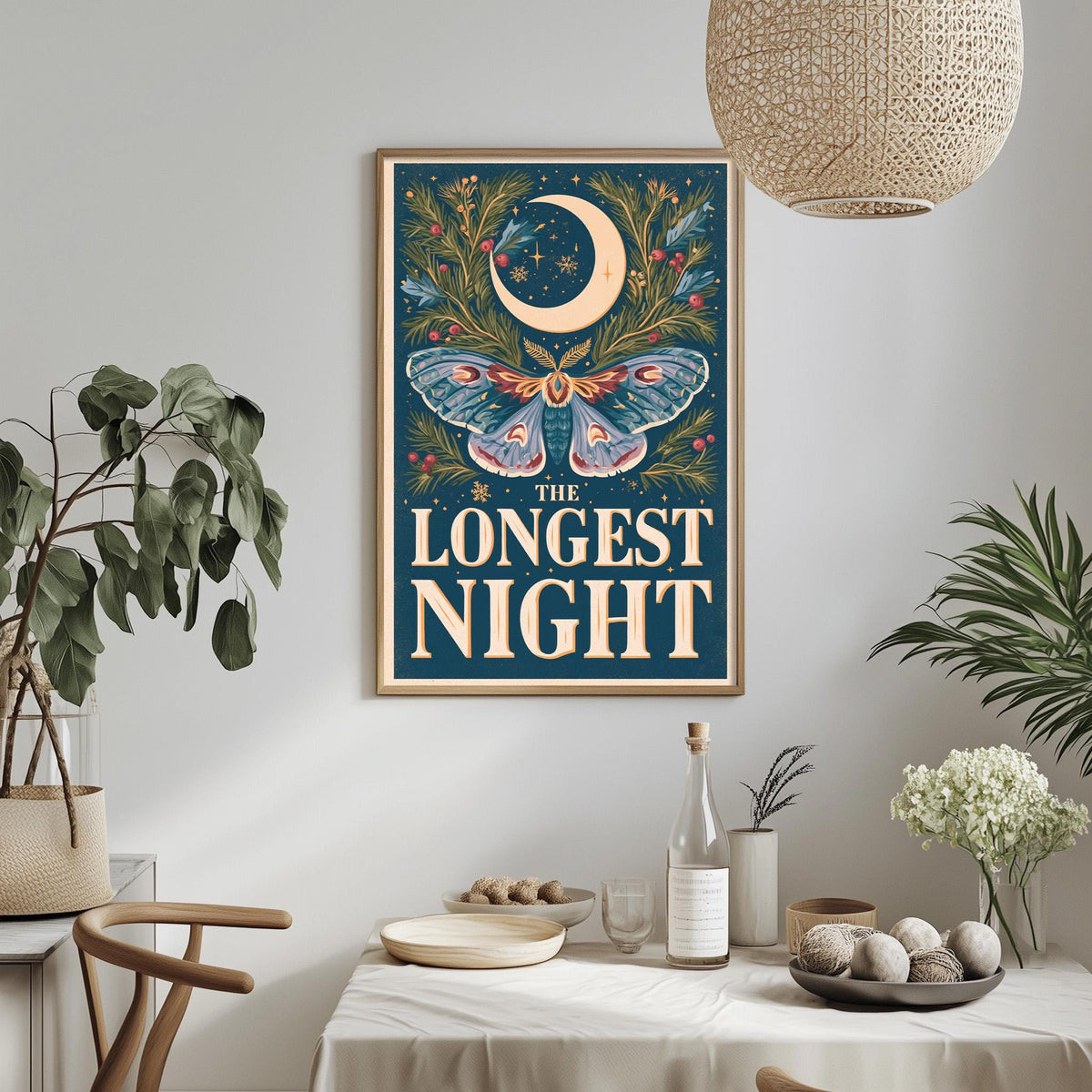 a framed poster with a crescent moon and butterfly design, hanging on a wall above a dining table with various decorative items and plants.