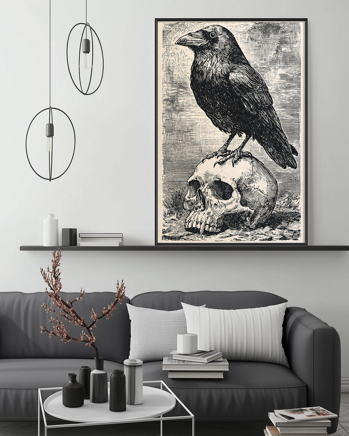a black and white illustration of a bird perched on a skull, which is displayed on the wall above a gray couch.