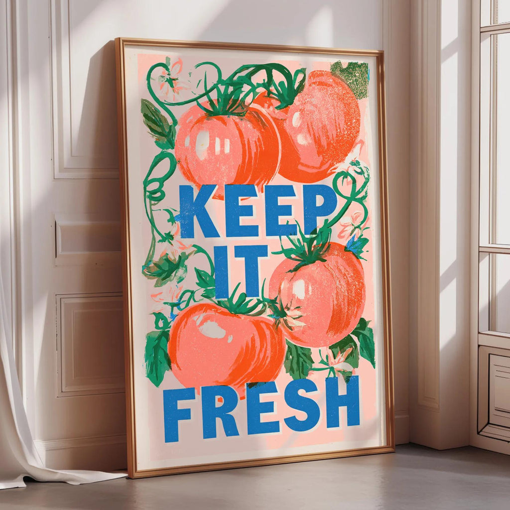 A framed poster with a vibrant design featuring tomatoes and the text "KEEP IT FRESH" is displayed on a wall.