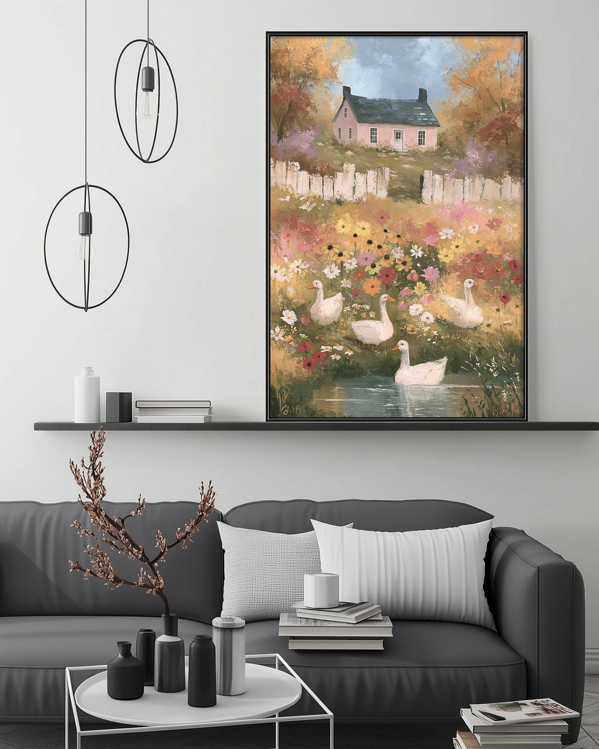 a cozy living room with a gray sofa, a coffee table, and a large painting of a serene landscape with ducks in a pond. The painting is hanging above the sofa, creating a focal point in the room.