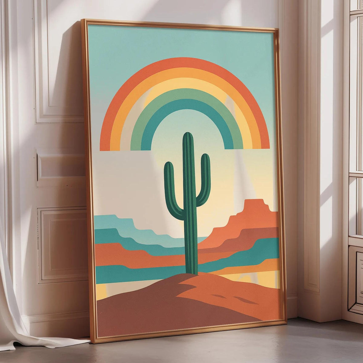 A framed poster depicting a cactus in a desert landscape with a rainbow arching over it, set against a colorful sky.