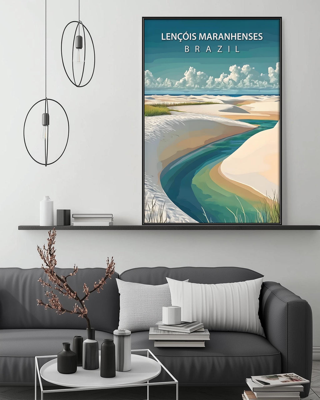 a large framed poster of a beach scene with a river, hanging on a wall above a gray couch with a coffee table in front of it.