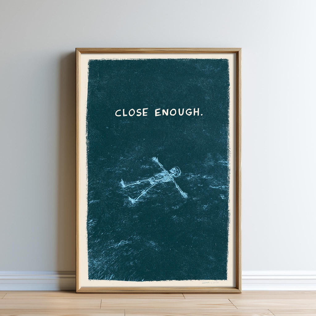 The image is a framed artwork with a blue background and a white text that reads "CLOSE ENOUGH".
