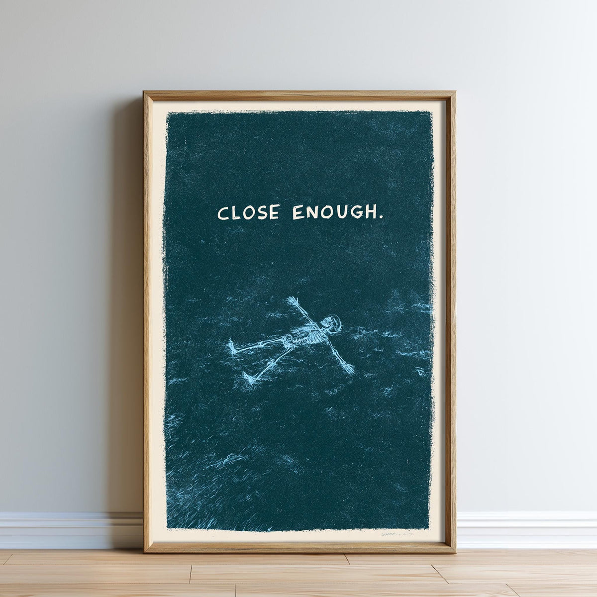 The image is a framed artwork with a blue background and a white text that reads "CLOSE ENOUGH".