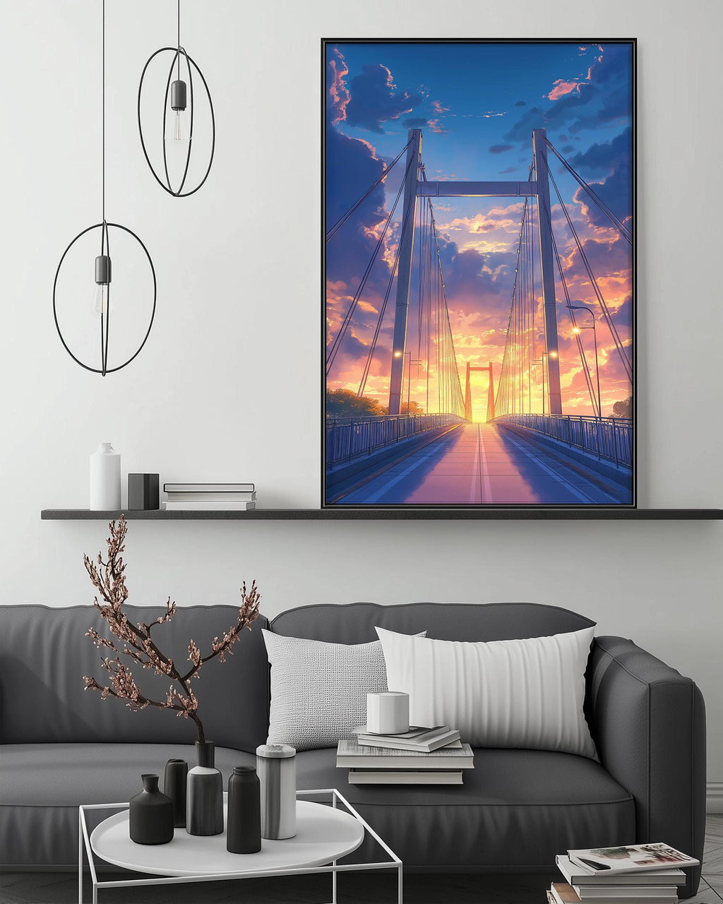 a large framed picture of a bridge with a colorful sunset in the background, hanging on a wall above a gray couch with a coffee table in front of it.