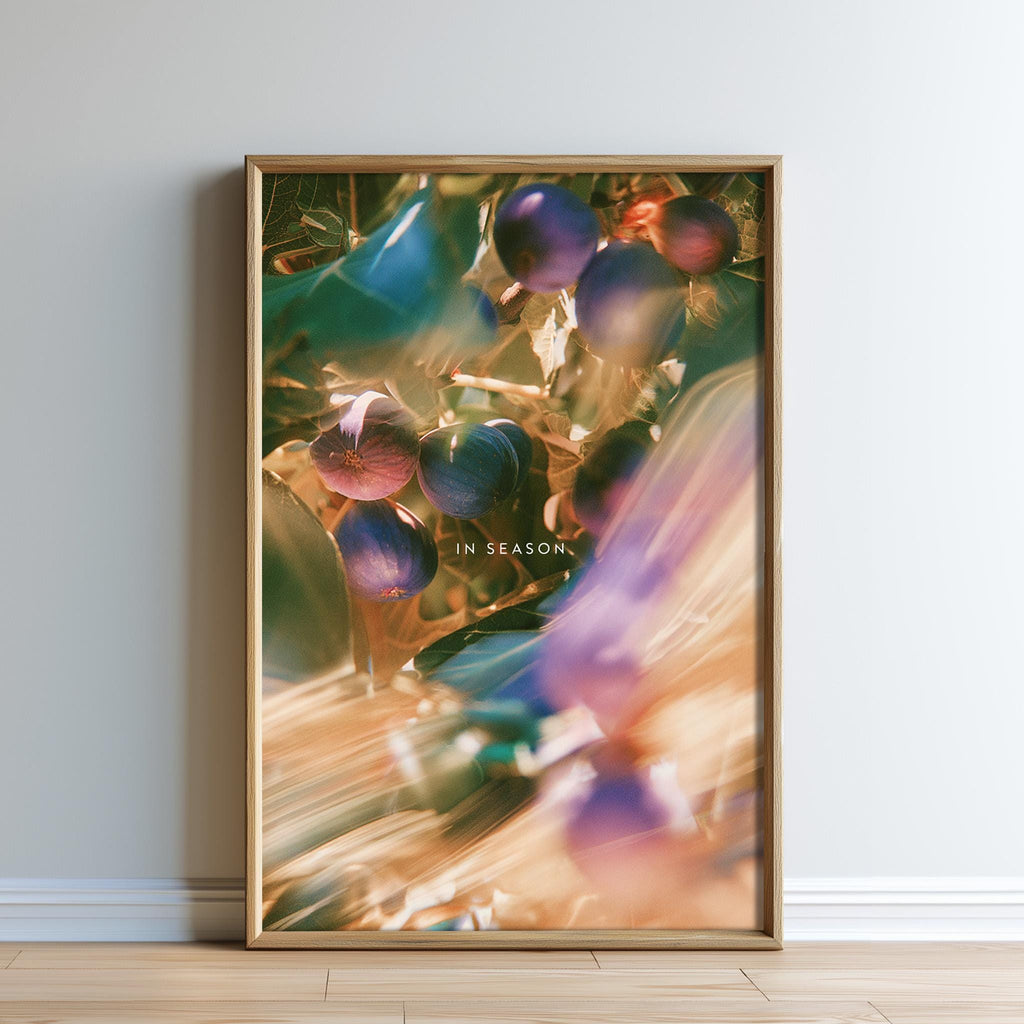 The image is a framed print of a blurred, colorful photograph of fruits and leaves, with the text "IN SEASON" visible.
