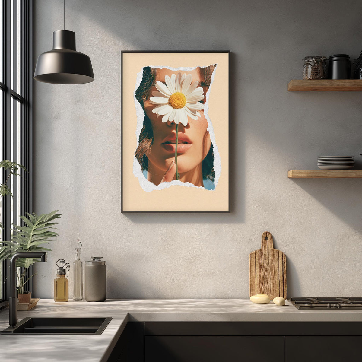 a framed artwork of a woman's face with a large white flower in her eye, hanging on a wall above a kitchen counter.