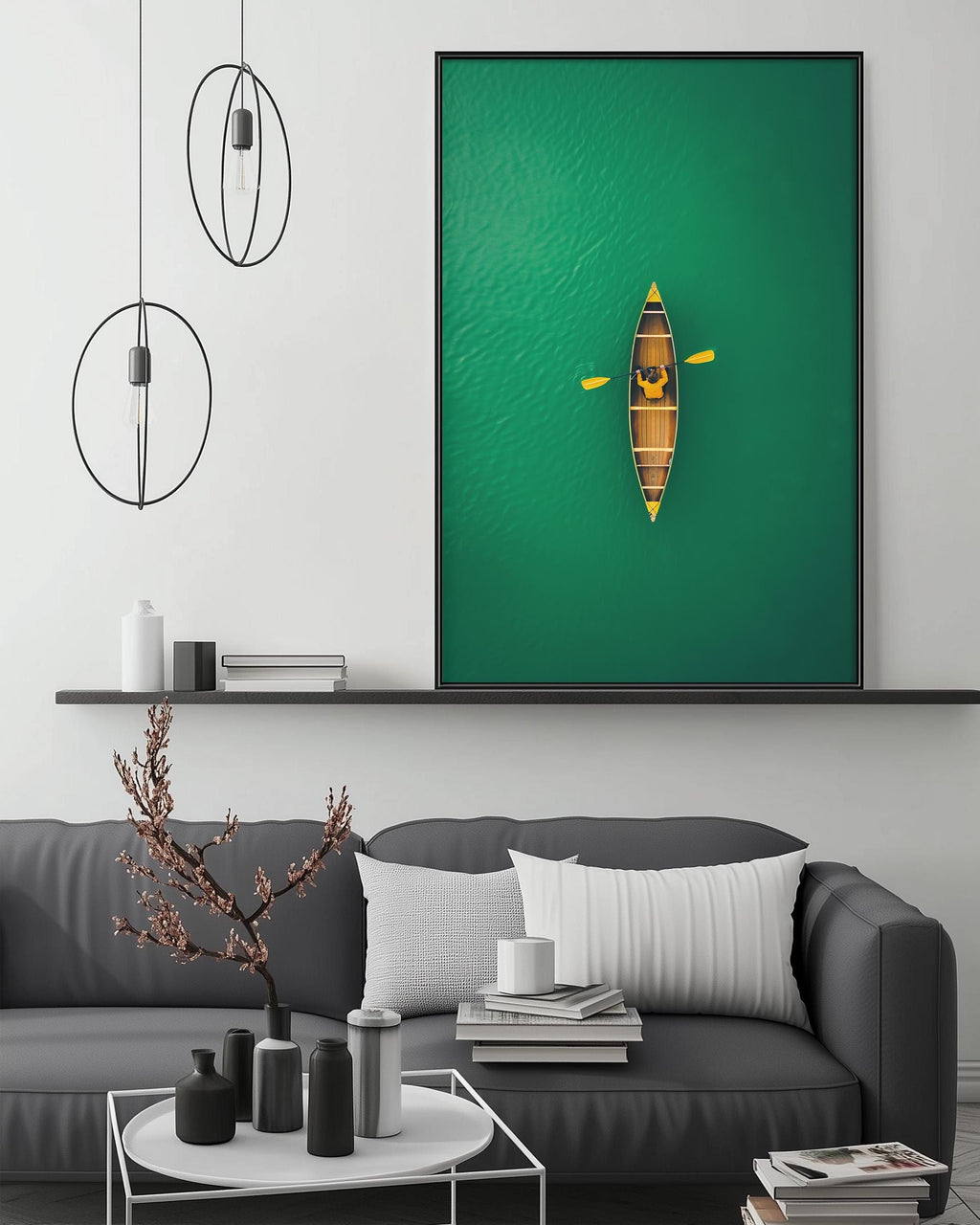 a modern living room with a gray sofa, a coffee table, and a large green wall art depicting a canoe on a lake.