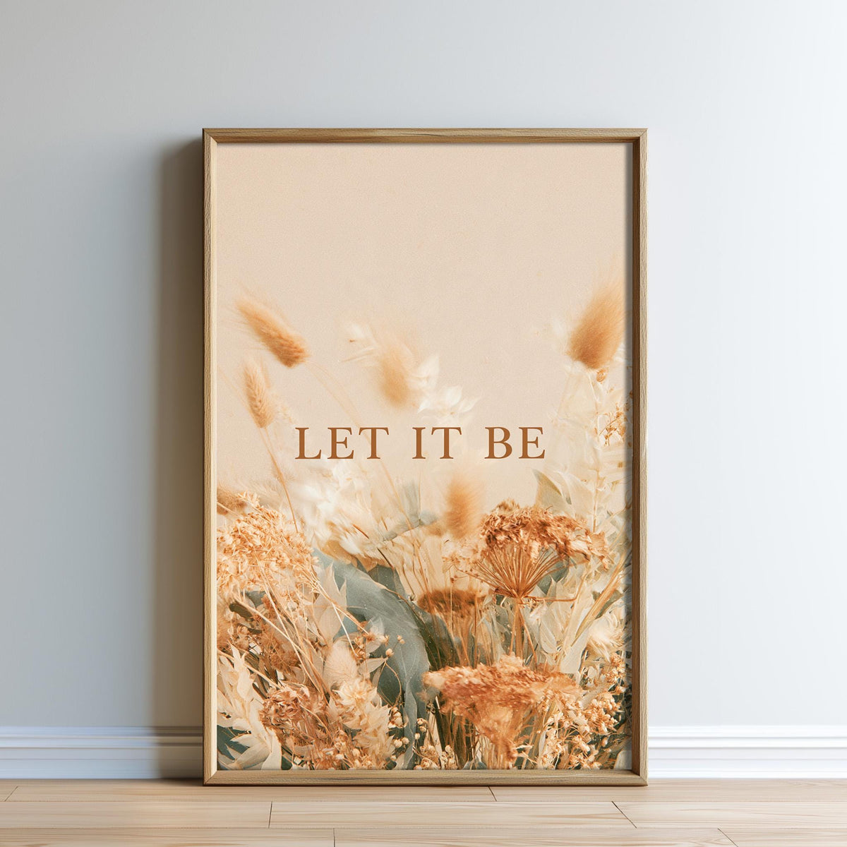 The image is a framed print with a floral design and the text "LET IT BE" displayed on it.