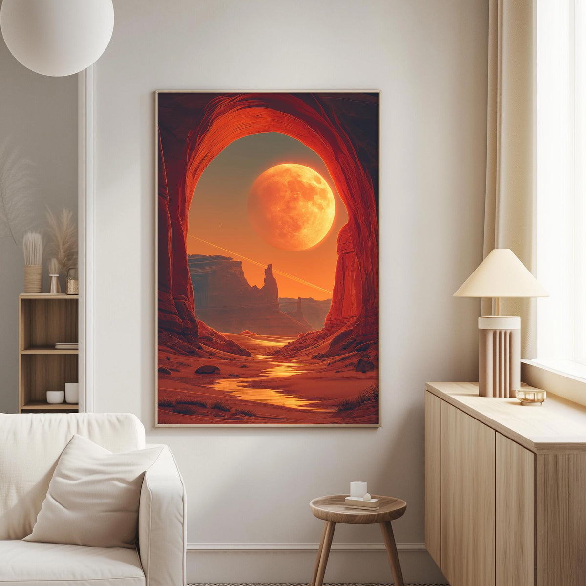a large, vibrant painting of a desert landscape with a large, glowing moon in the sky. The painting is hanging on a wall in a living room setting, with a white couch and a small table nearby.