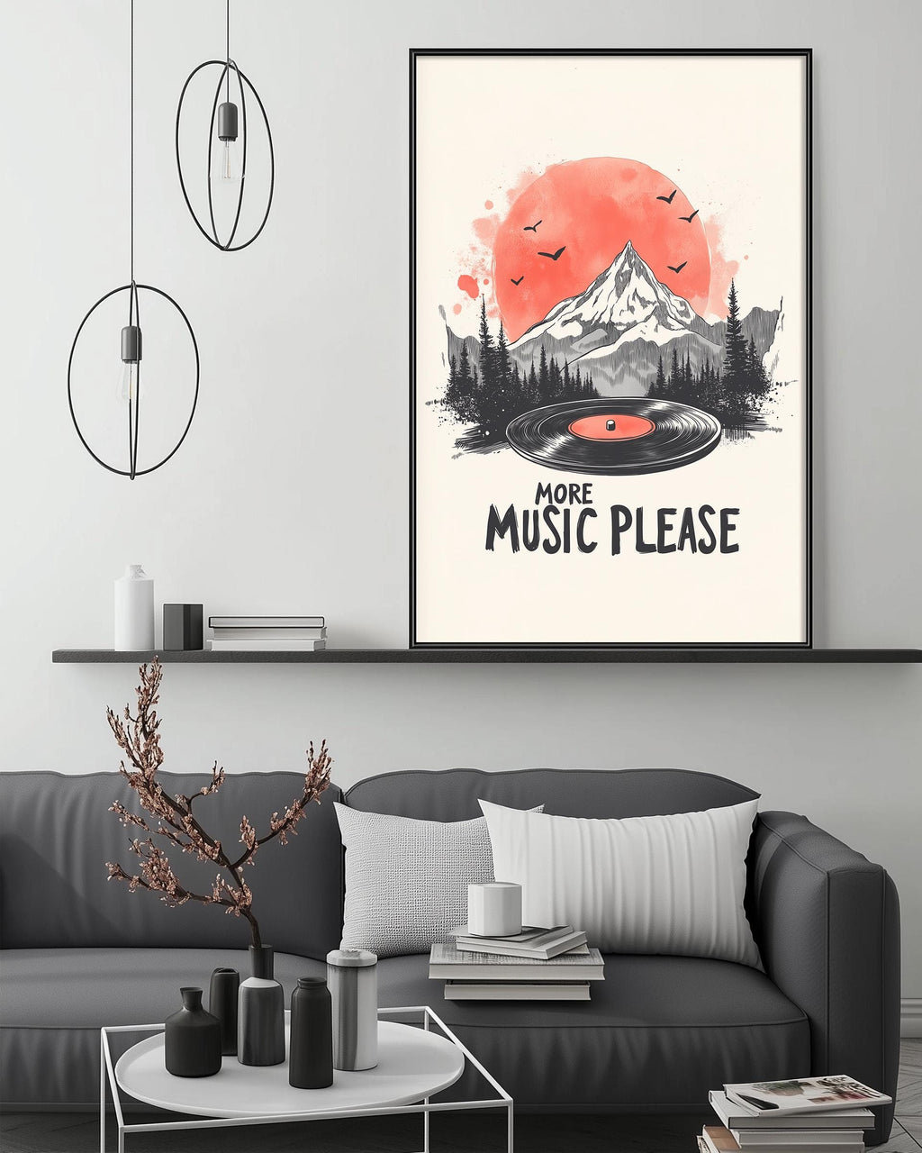 a living room with a gray couch, a coffee table, and a framed poster on the wall. The poster has a mountain landscape with a record player and birds in the sky, along with the text "MORE MUSIC PLEASE".