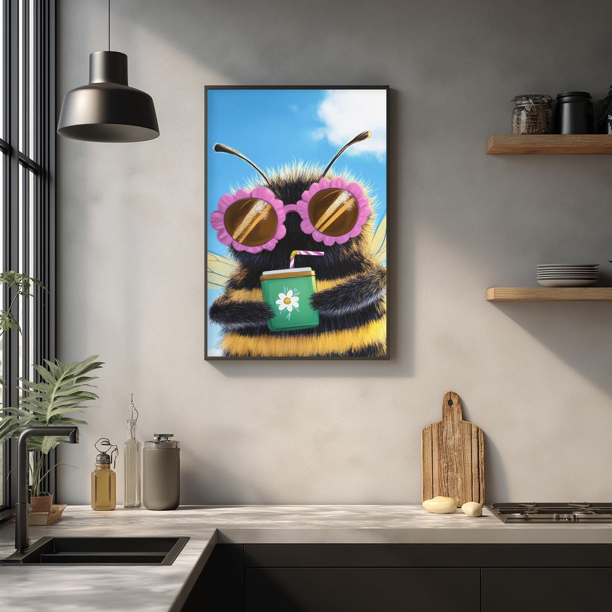 a framed picture of a bee wearing sunglasses and holding a drink, hanging on a wall in a kitchen setting.