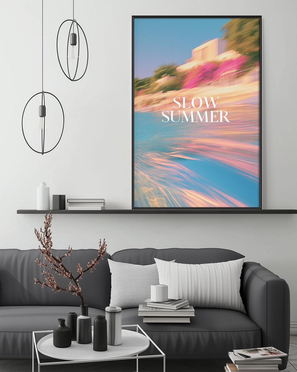 a modern living room with a gray sofa, a coffee table, and a large framed poster with a beach scene on the wall.
