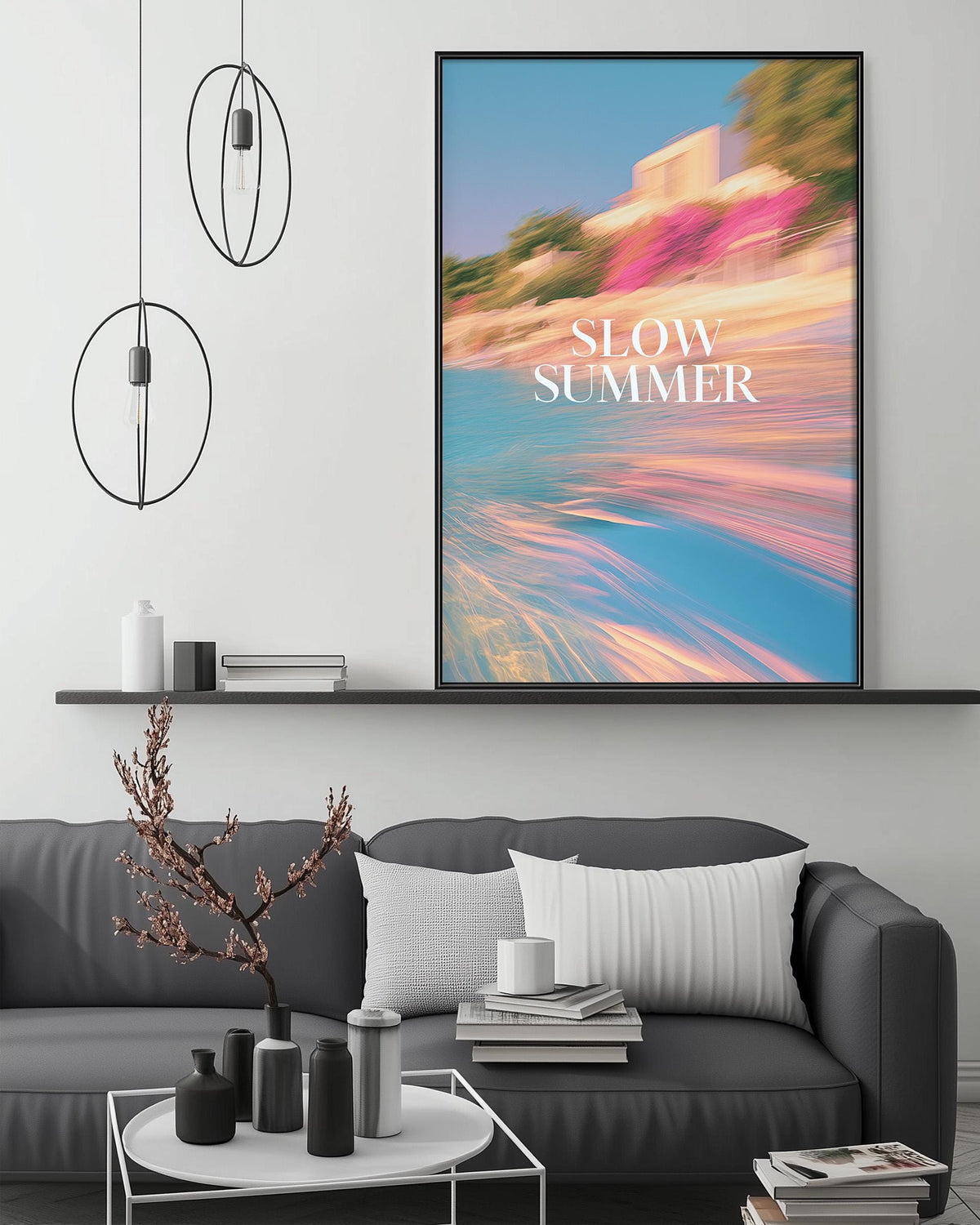 a modern living room with a gray sofa, a coffee table, and a large framed poster with a beach scene on the wall.