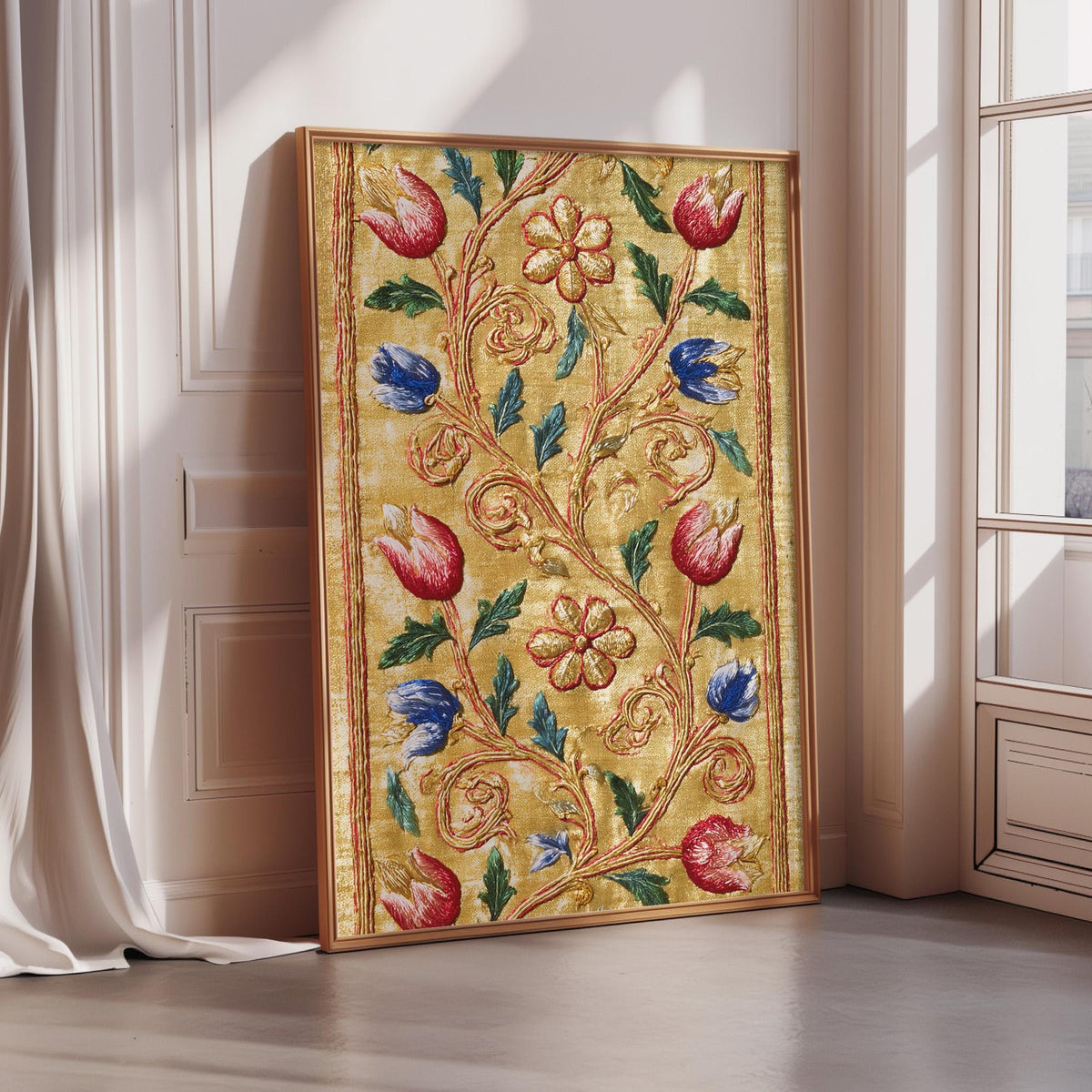A framed artwork with a gold frame and a vibrant floral design in red, blue, and green colors is displayed on a wall.