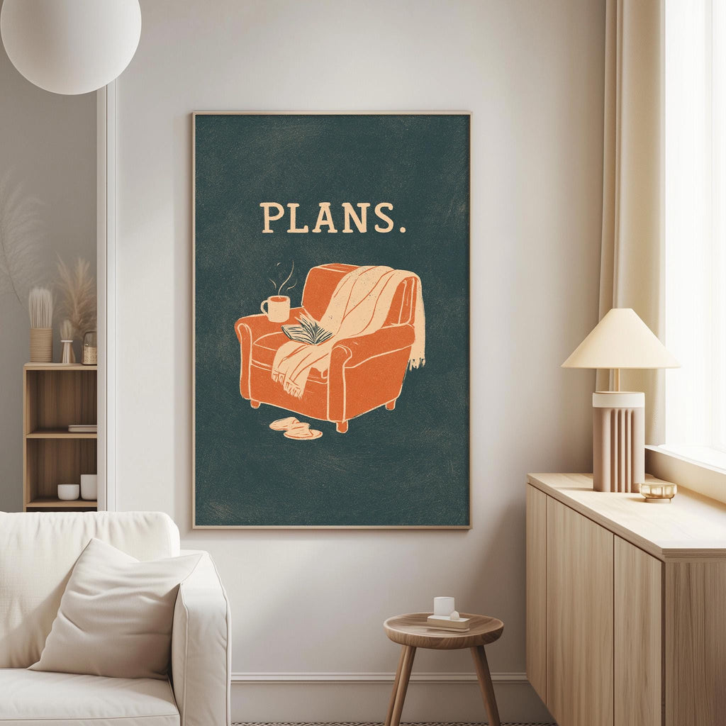 a cozy living room with a large framed poster of an orange armchair with a blanket and a cup of coffee on it, hanging on the wall.