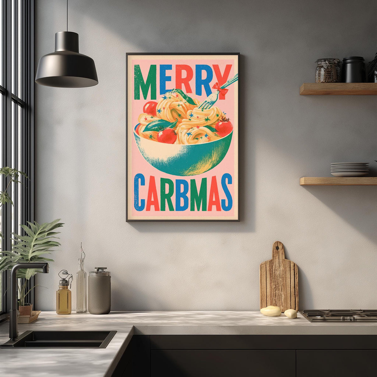 A framed poster with the text "MERRY CARBMAS" hangs on a wall above a kitchen counter with various kitchen items and decor.