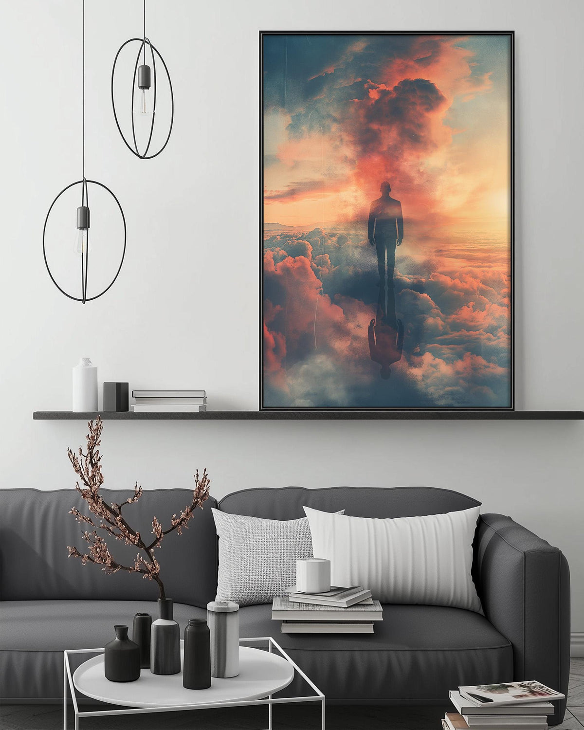 a large, colorful painting of a person standing in the clouds, with a dramatic sky in the background. The painting is displayed on the wall above a gray couch, which has a coffee table in front of it. The room has a minimalist and modern design, with a few decorative items such as a potted plant, vases, and books.