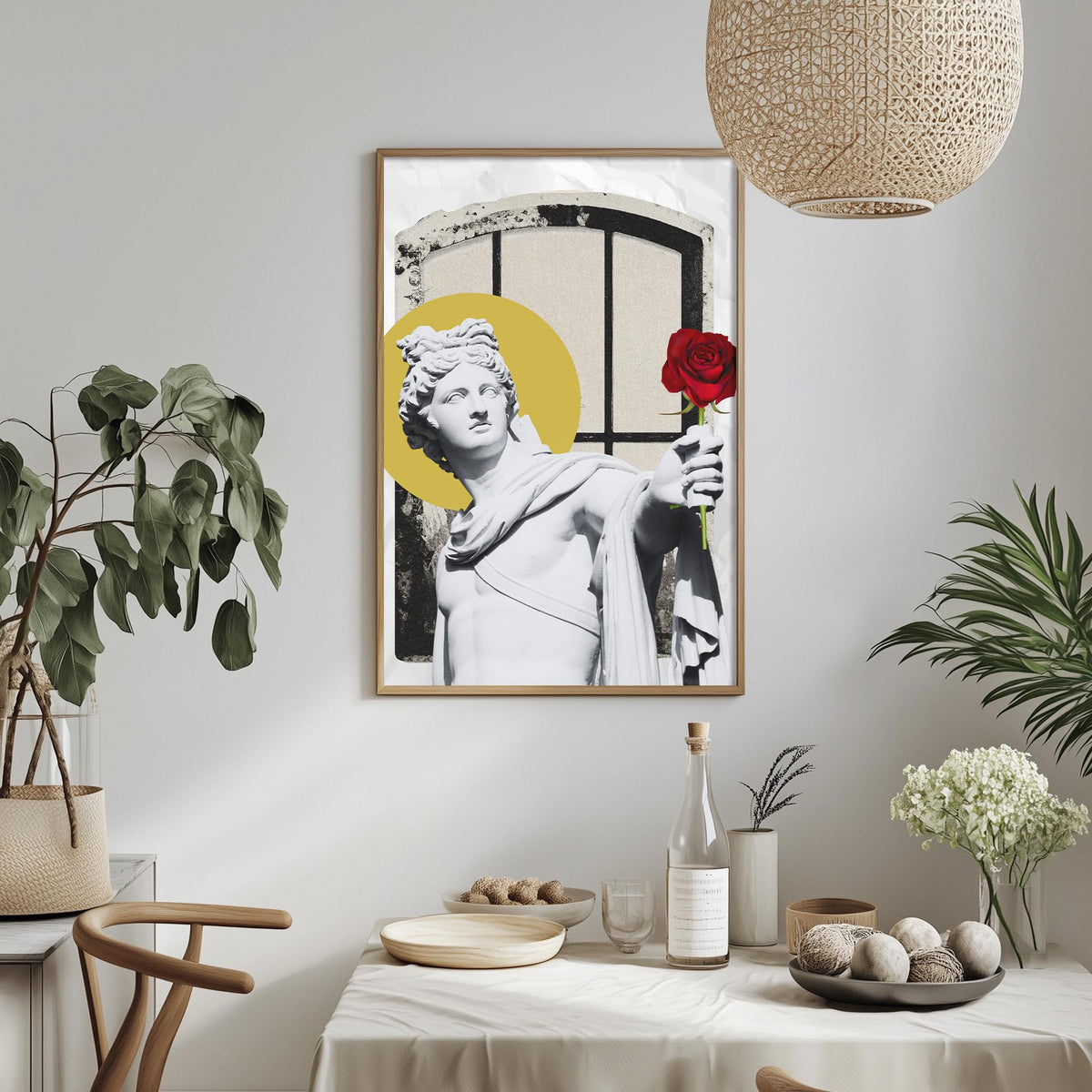 a framed artwork of a statue holding a red rose, surrounded by various decorative elements such as potted plants, vases, and bowls on a table.