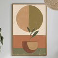 a dining table with a white tablecloth, a bowl of fruit, a bottle, and a vase with flowers. Above the table, there is a framed abstract painting depicting a plant in a bowl.