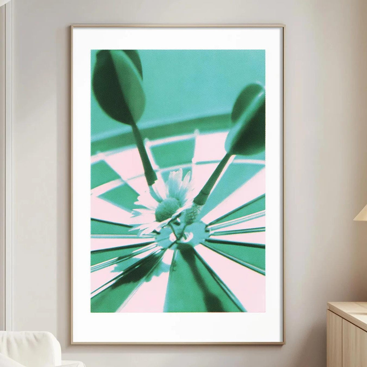 a living room with a white sofa, a wooden side table, and a framed artwork depicting a close-up of a dartboard with a flower in the center.