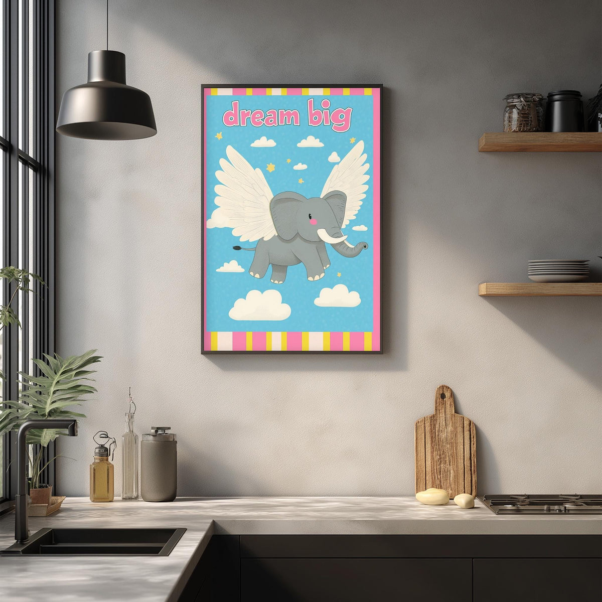 a kitchen counter with various items on it, such as a cutting board, a soap dispenser, and a bottle. Above the counter, there is a framed poster of an elephant with wings, and the text "dream big" is written on it.