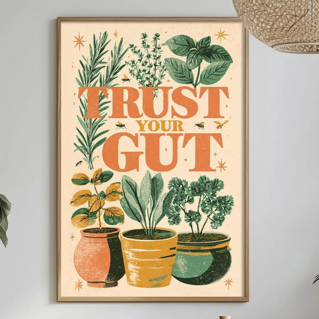 a framed poster with a vibrant illustration of potted plants and the text "TRUST YOUR GUT" hanging on a wall above a dining table with various decorative items.