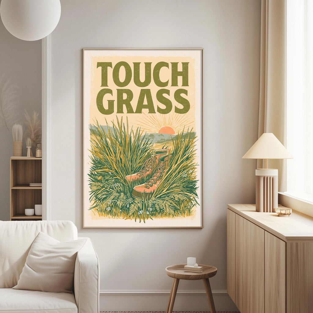 a poster of a field of tall grass with a sun in the background, hanging on a wall in a living room.
