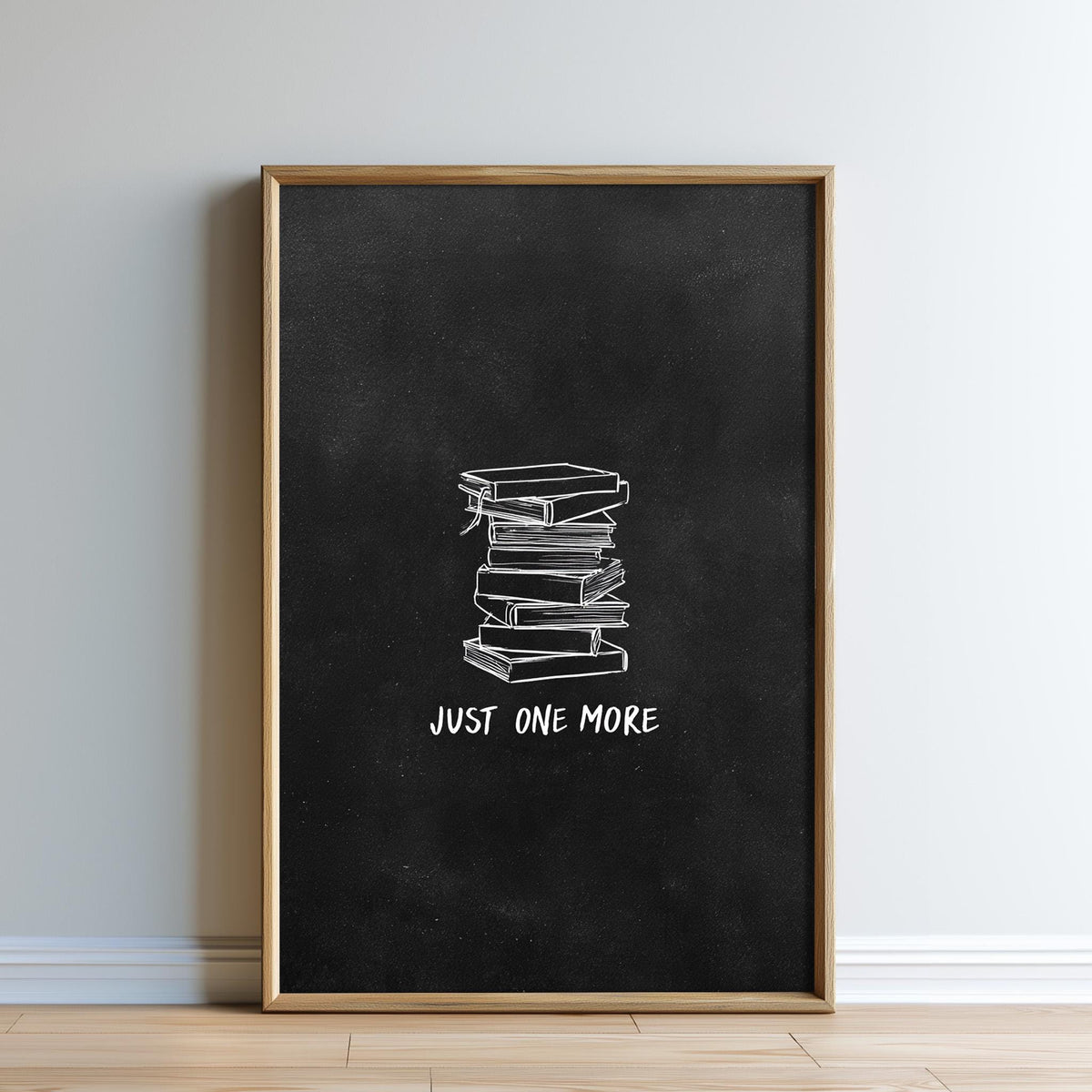 A framed poster with a black background and white text, depicting a stack of books.