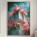 a large framed painting of a building with pink flowers on its facade, hanging on a wall in a living room setting.