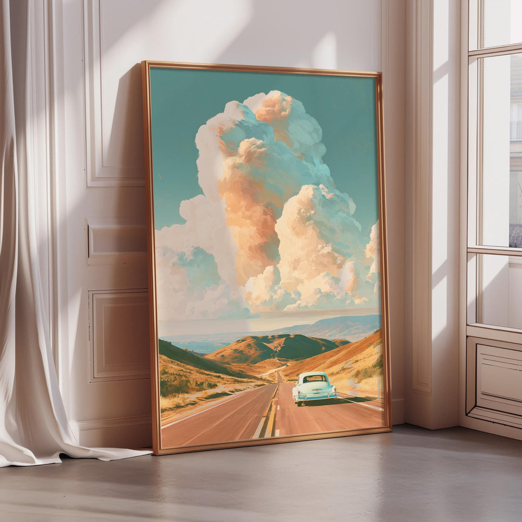 The image is a framed painting depicting a scenic road with a car driving down the road, surrounded by mountains and a cloudy sky.