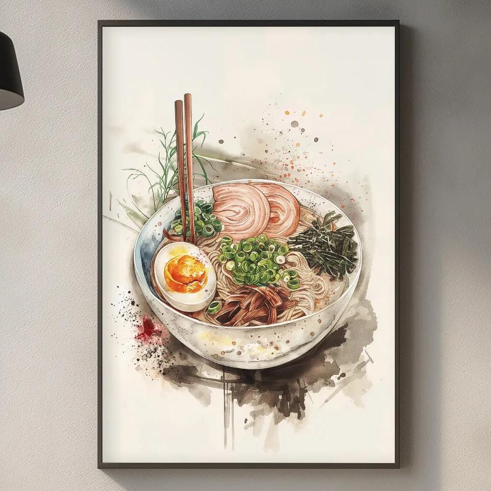 a kitchen scene with a framed print of a bowl of ramen noodles hanging on the wall above a countertop with various kitchen items such as a cutting board, a bottle, and a vase.