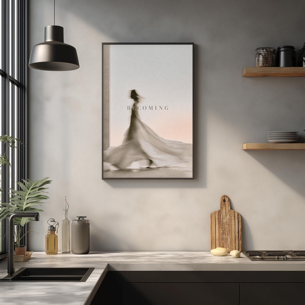 a kitchen counter with a framed poster of a woman in a flowing dress, a wooden cutting board, and various kitchen items such as a bottle, a vase, and a bowl.