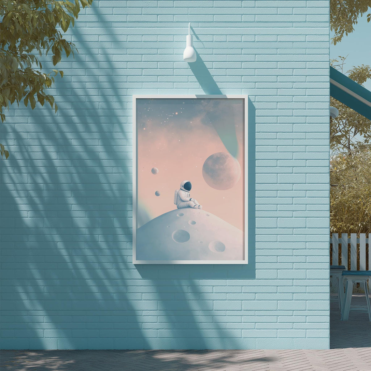 a blue brick wall with a framed poster of an astronaut sitting on a planet hanging on it.