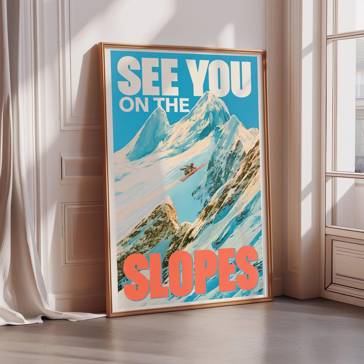 A framed poster with a mountain landscape and the text "See You on the Slopes" is displayed on a wall.