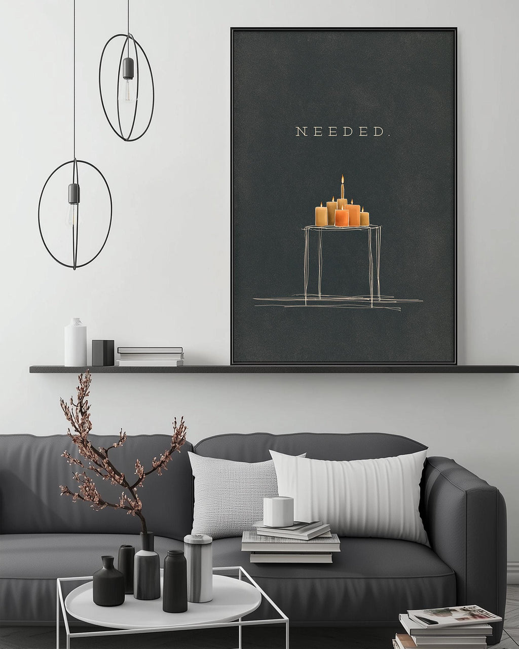 a modern living room with a gray sofa, a coffee table, and a large black and white artwork hanging on the wall. The artwork depicts a table with a lit candle, and the word "NEEDED" is written above it.