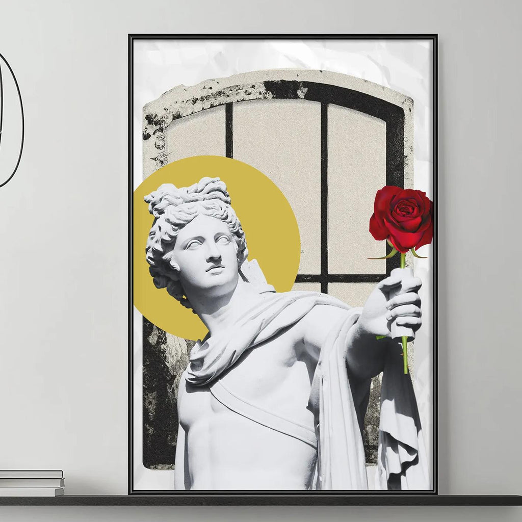 a modern living room with a gray sofa, a coffee table, and a large framed artwork depicting a statue of a man holding a red rose. The artwork is mounted on the wall above the sofa, creating a focal point in the room.