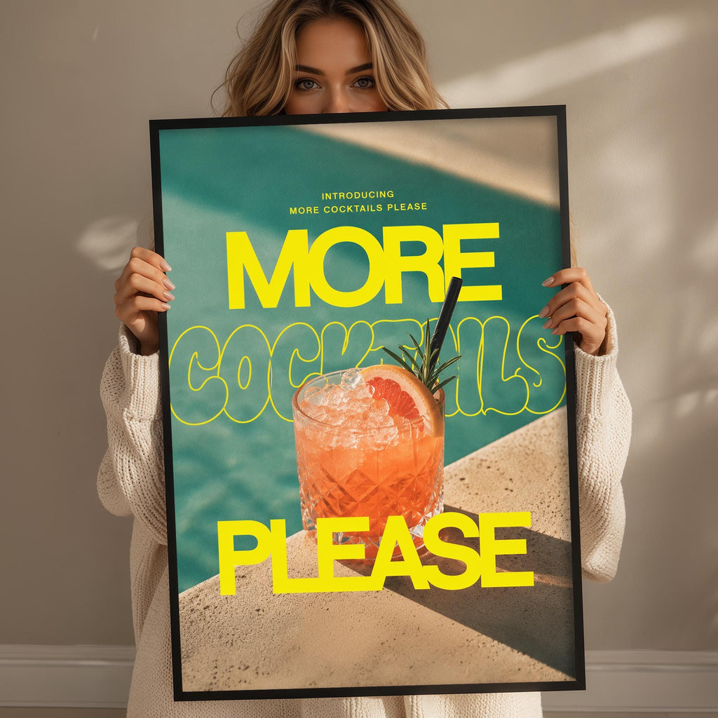 A woman holding a framed poster with a large text that says "MORE COCKTAILS PLEASE" and an image of a cocktail.