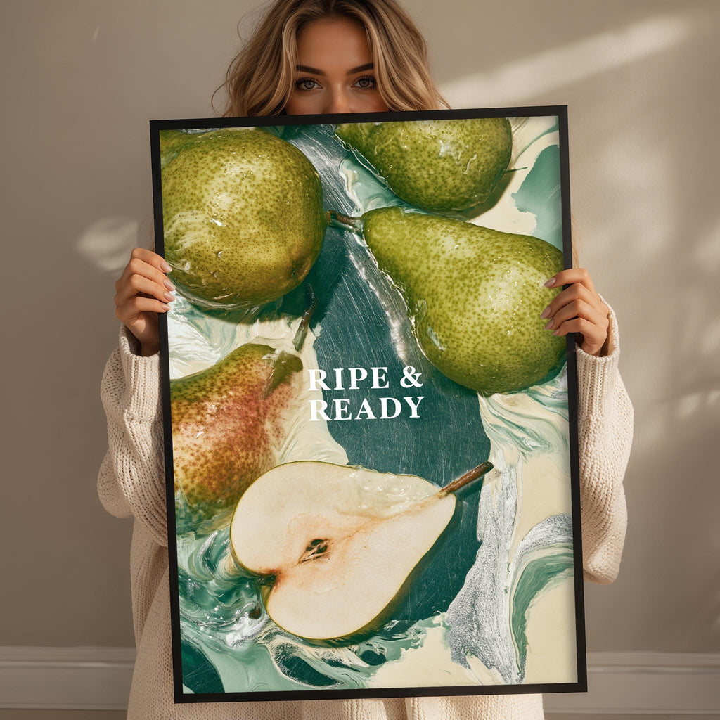 A woman holding a framed print with a collage of images featuring pears and a green leaf.