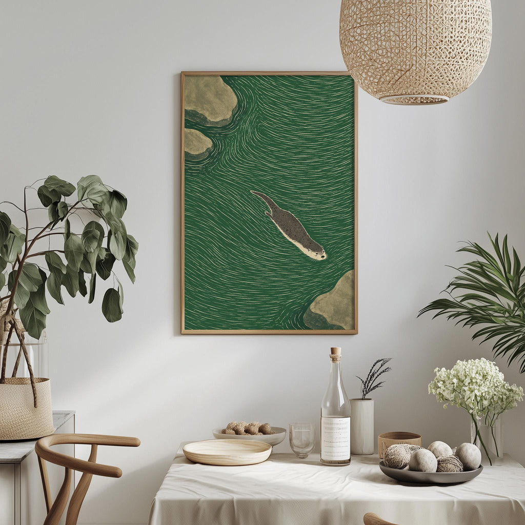 a dining table with a white tablecloth, a bowl of fruit, a bottle, and a vase with flowers. Above the table, there is a framed picture of a seal swimming in the ocean.