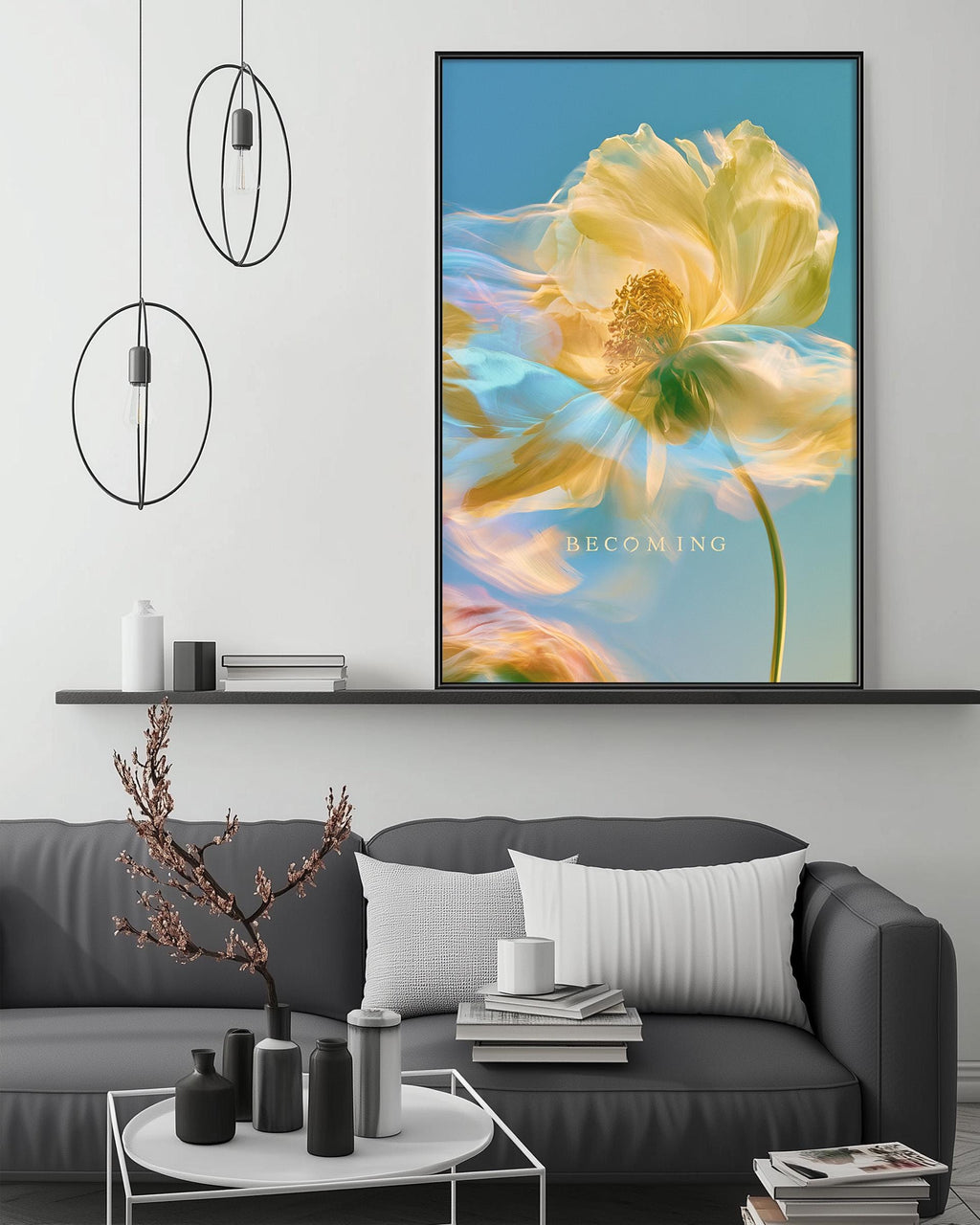 a large framed artwork depicting a vibrant yellow flower with a green stem, hanging on a wall above a gray couch with white pillows. The artwork is surrounded by various decorative items, including a potted plant, vases, and books, creating a cozy and inviting atmosphere in the living room.