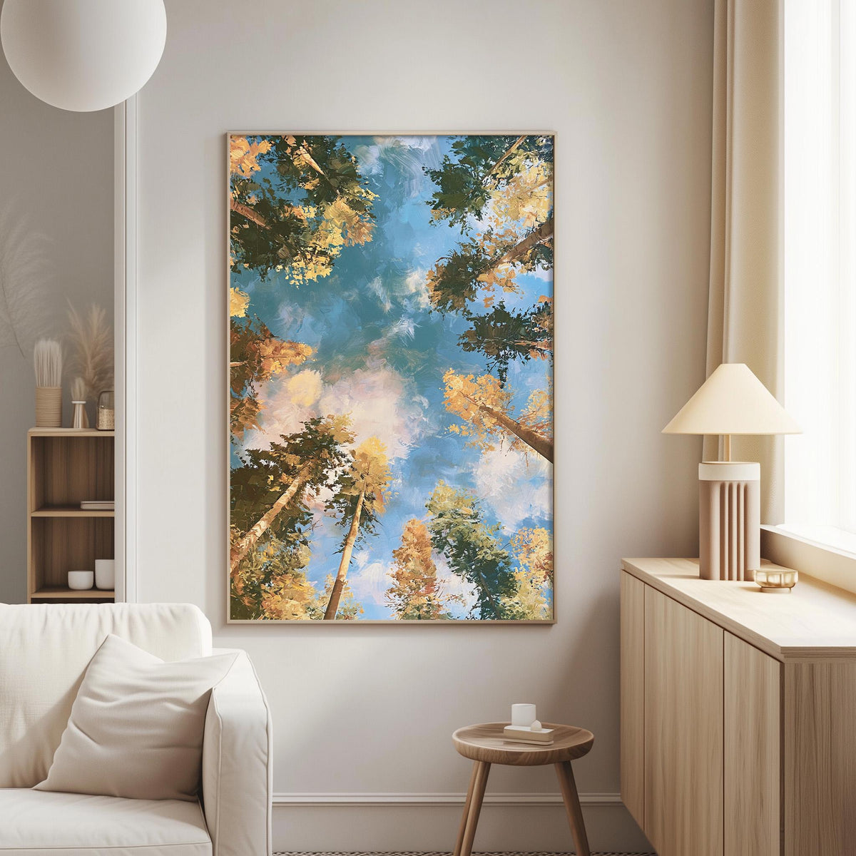 a serene living room with a large framed painting of a forest scene hanging on the wall, featuring a blue sky with clouds and trees in various shades of green and yellow.