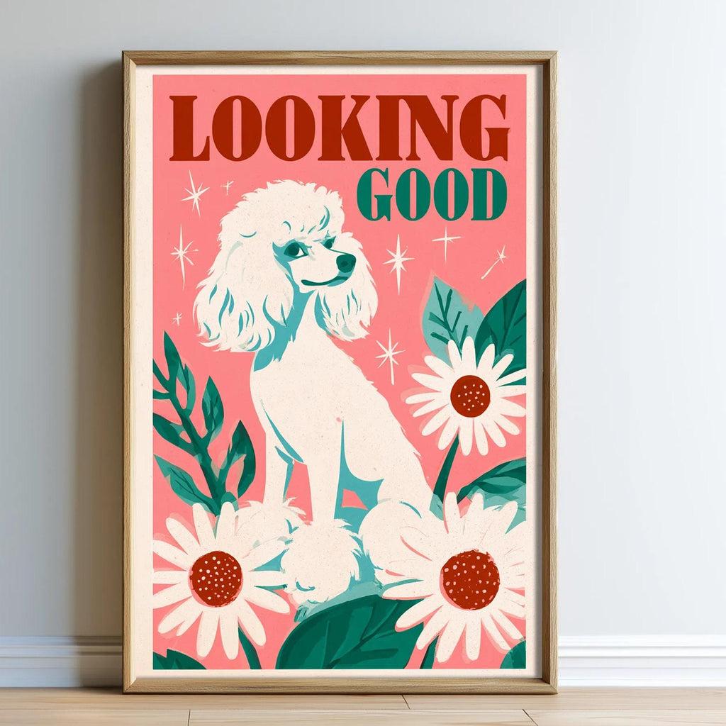 A framed poster with a white poodle sitting amidst flowers and leaves, with the text "Looking good" prominently displayed.