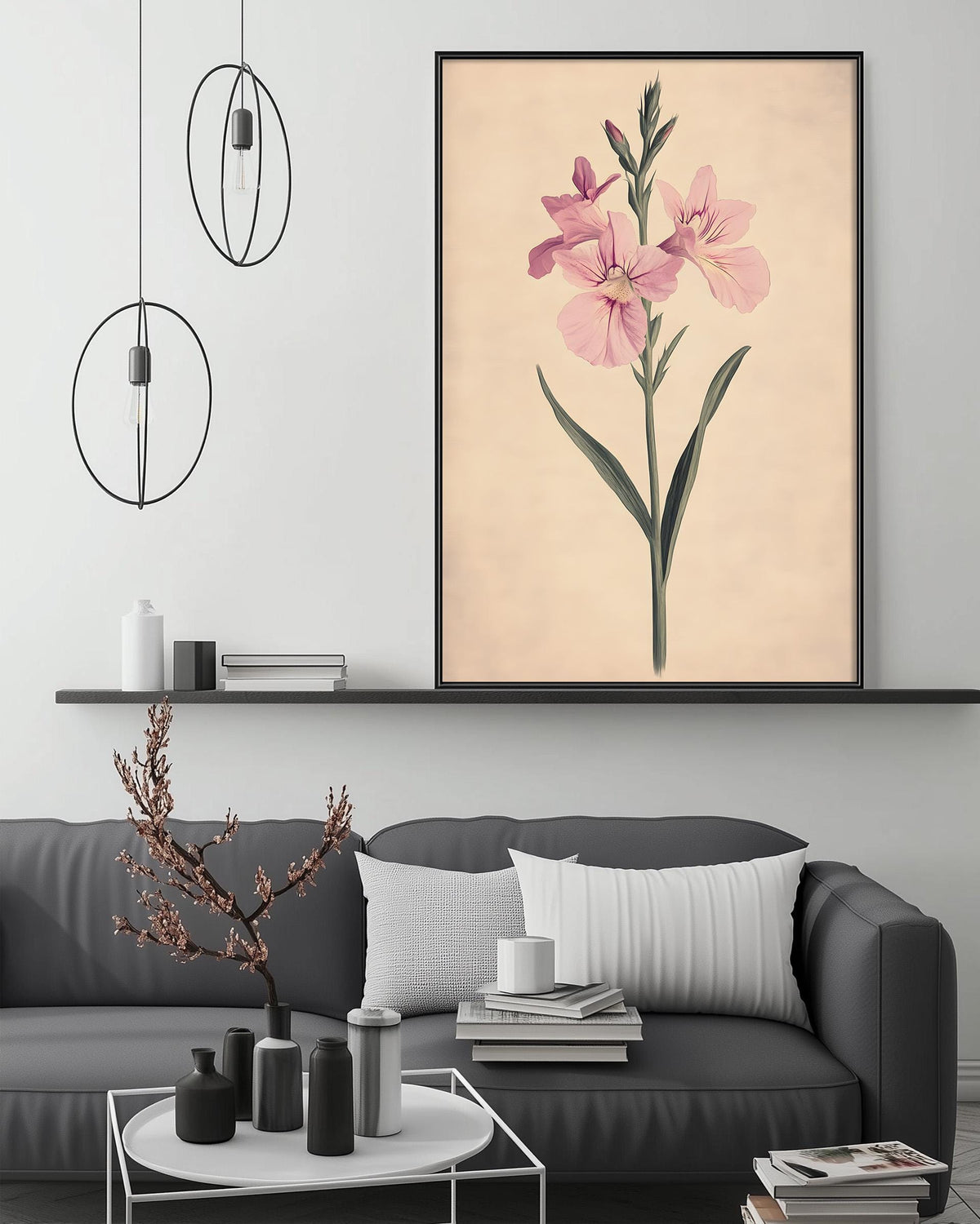 a living room with a gray sofa, a coffee table, and a large framed print of a pink flower on the wall above the sofa.