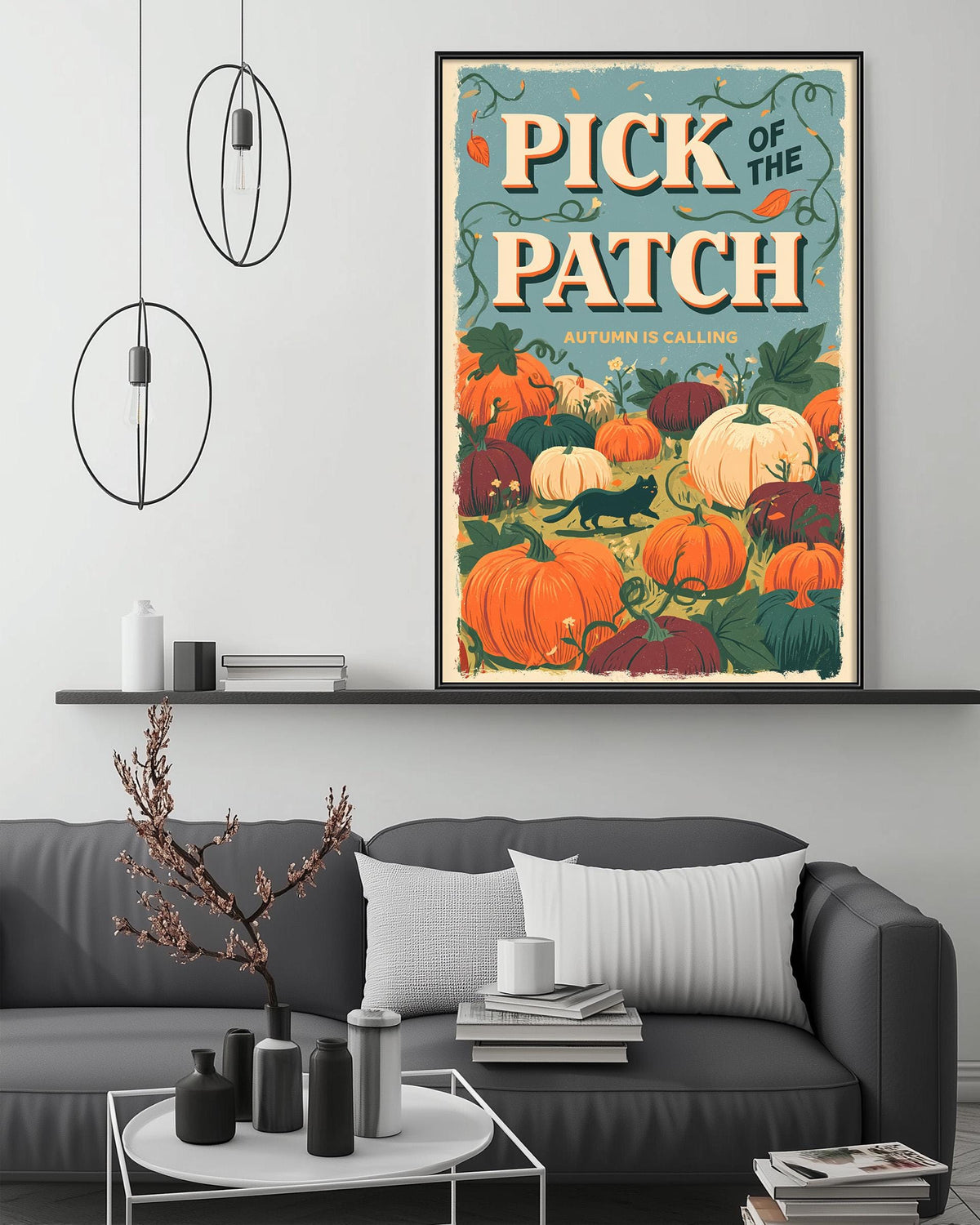 a cozy living room with a gray couch, a coffee table, and a framed poster of pumpkins hanging on the wall.