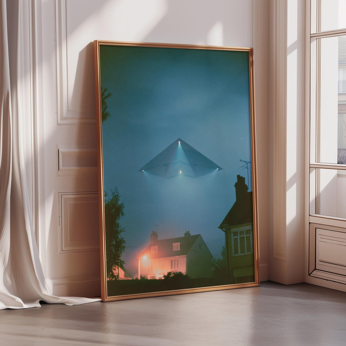 a large framed picture of a house with a triangular-shaped object flying above it, creating an illusion of the house being photographed by the flying object.